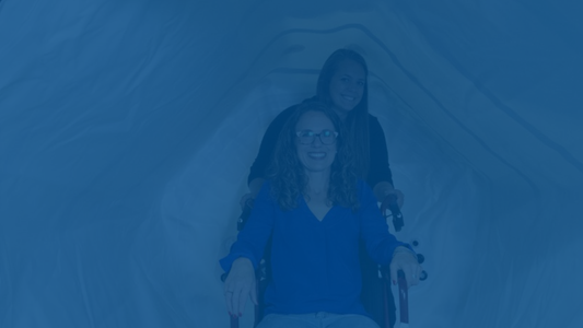 Two people inside a rented hyperbaric chamber at home
