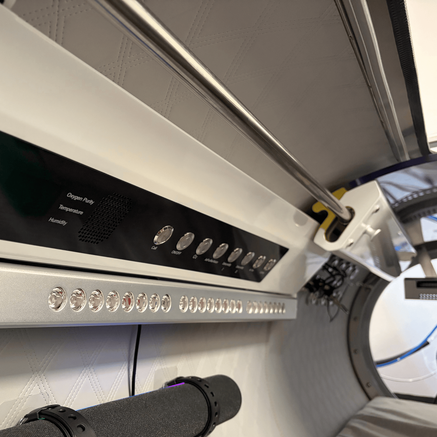 30 inch Hyperbaric chamber with a red light therapy panel looking towards the foot end.